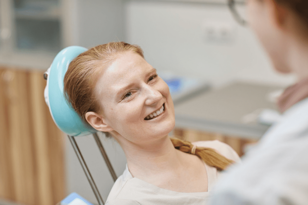 patient lying on dental chair and smiling