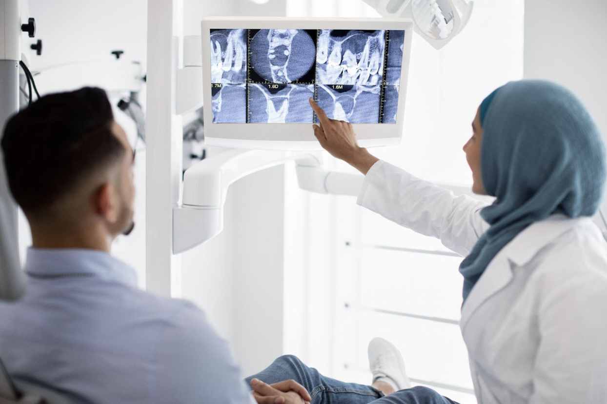 dentist showing patient xray of teeth