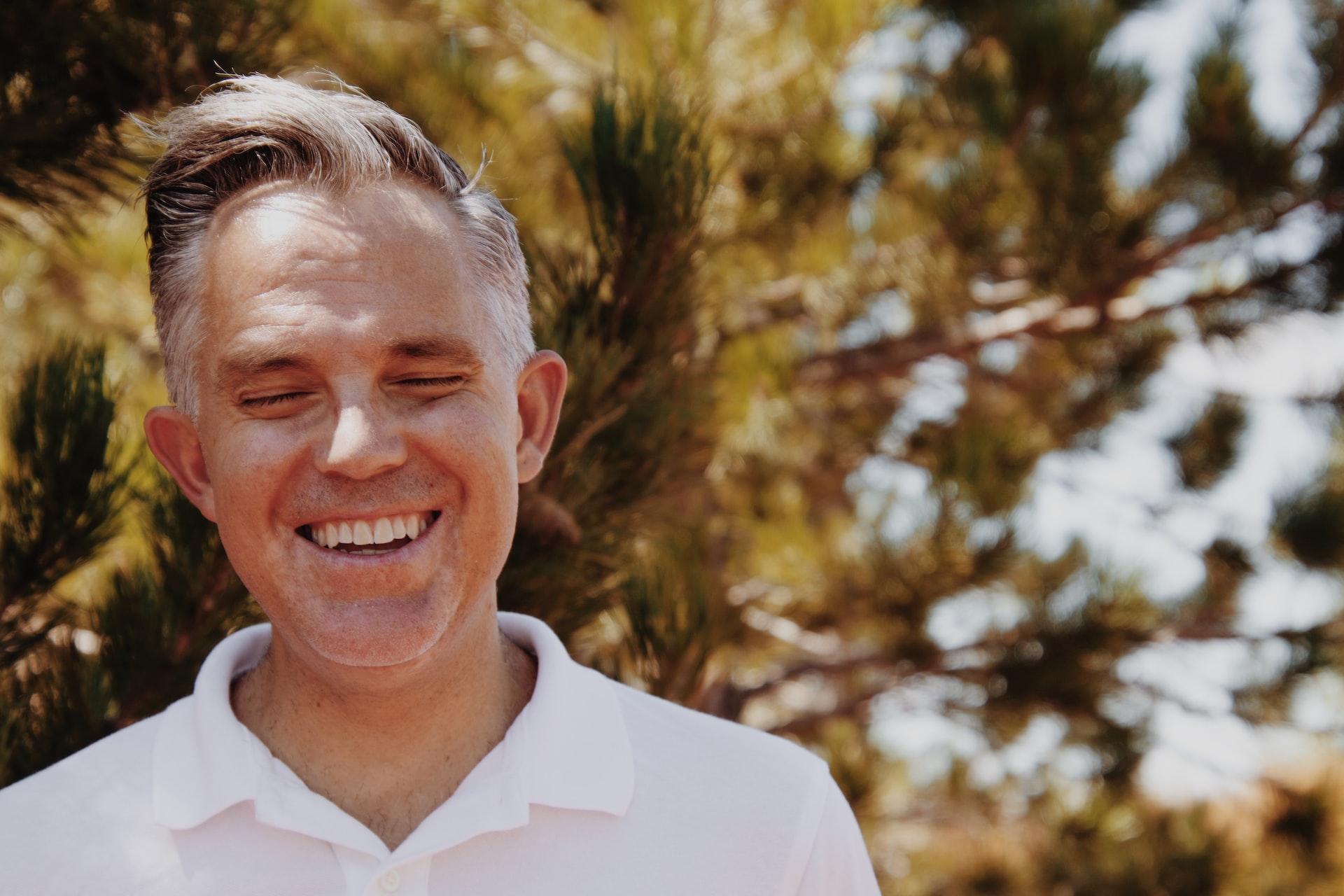 smiling man with closed eyes