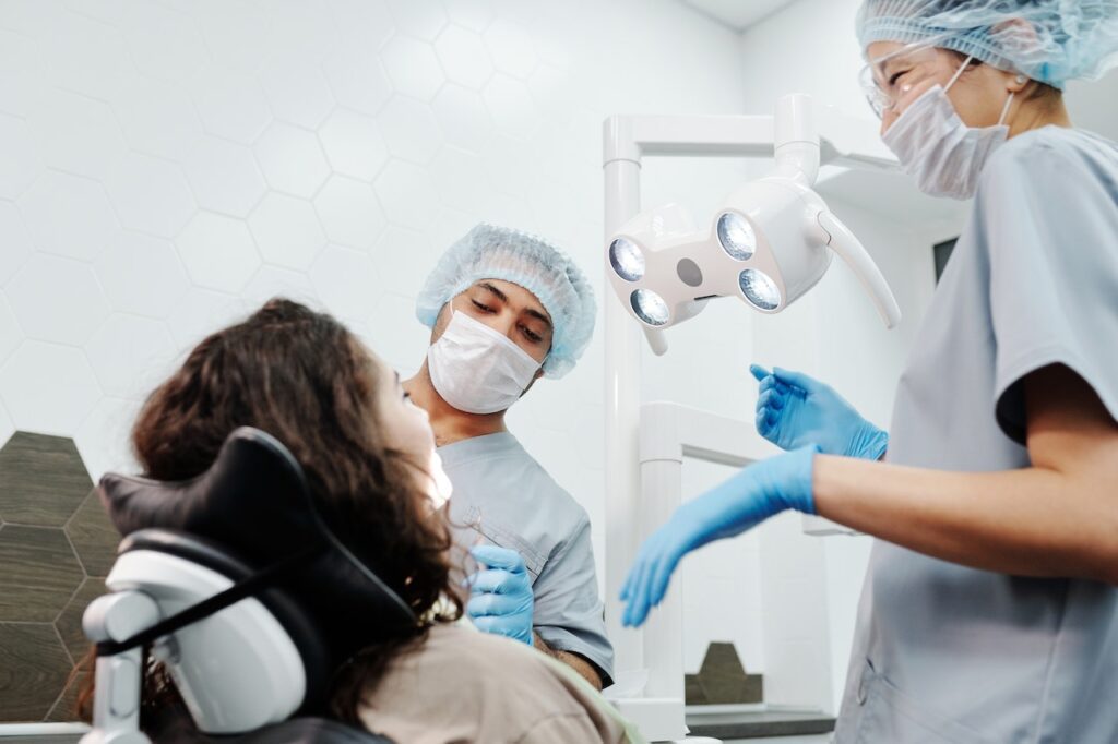 patient checkup with dentist and assistant