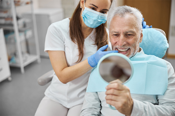 An aging gentleman happy with his new dental implant