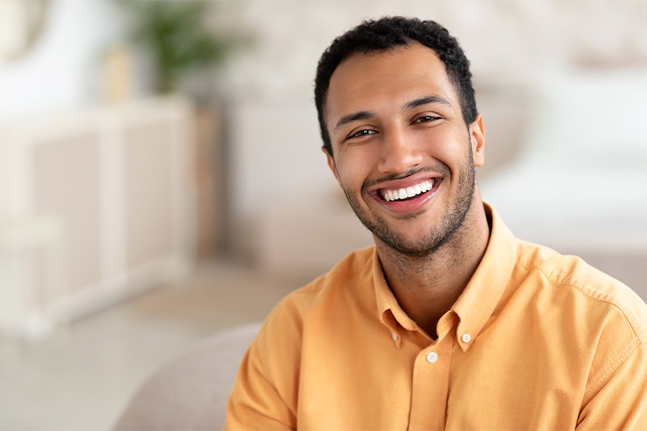 Man in button-up shirt smiling