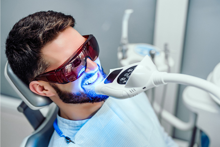 A man having his teeth whitened at the dental office