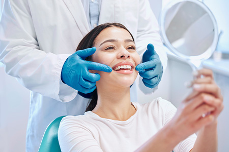 A dental patient smiling during an appointment