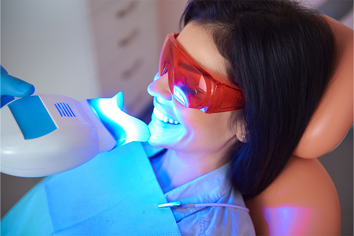 A patient smiling while receiving teeth whitening