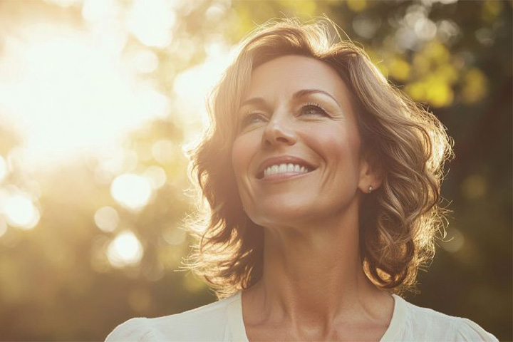 Smiling middle-aged woman enjoying time outdoors.