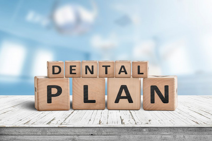 Building blocks spell “dental plan”.
