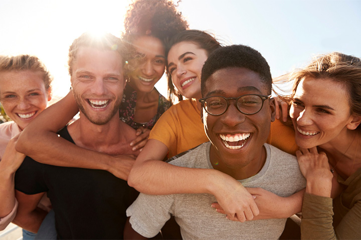 Group of friends laughing and smiling together.
