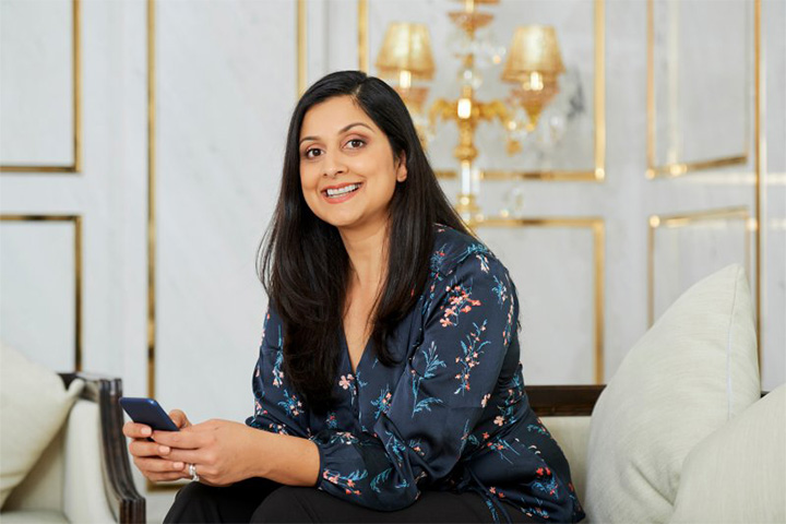 Lady smiles in fancy room.