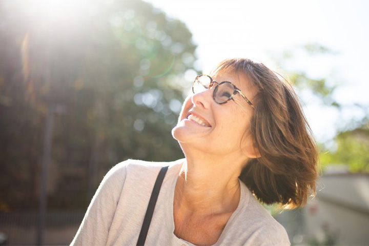 Lady smiles outdoors.