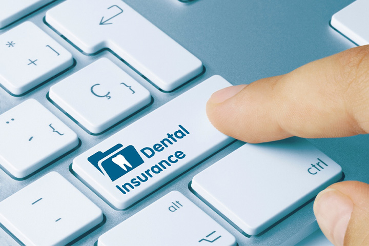 Person clicking on Dental Insurance button on keyboard.