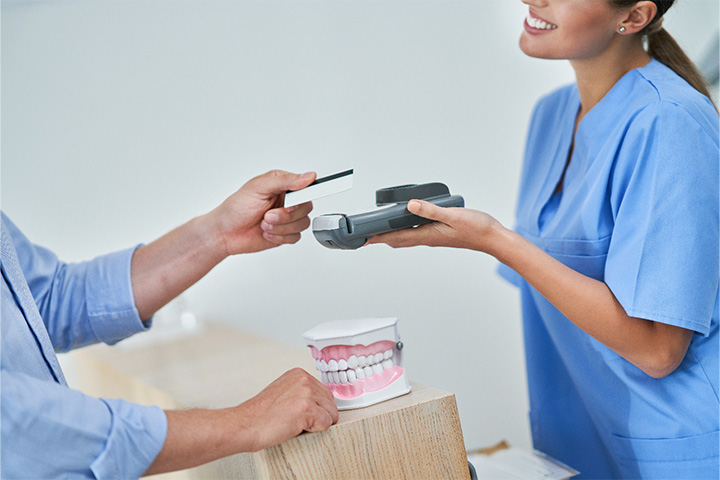 Person making a payment on their Invisalign treatment.