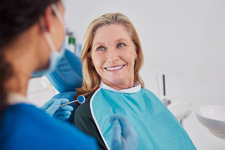 A patient smiling while visiting her dentist.